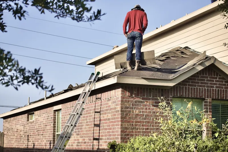 Professional roofer working on a residential roof in Garden Lakes